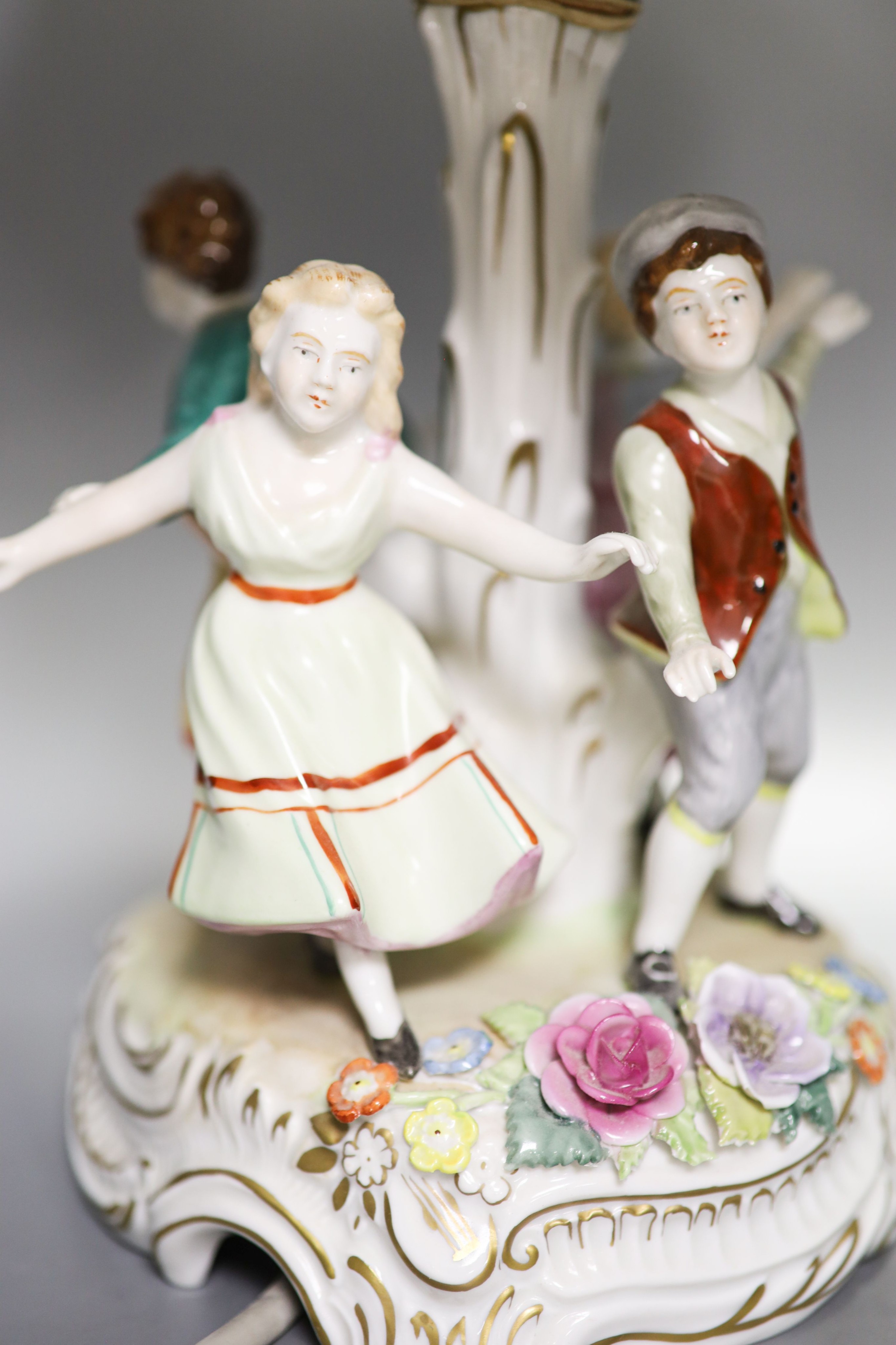 Two pairs of German porcelain table lamps, the stems modelled with figures dancing 56cm